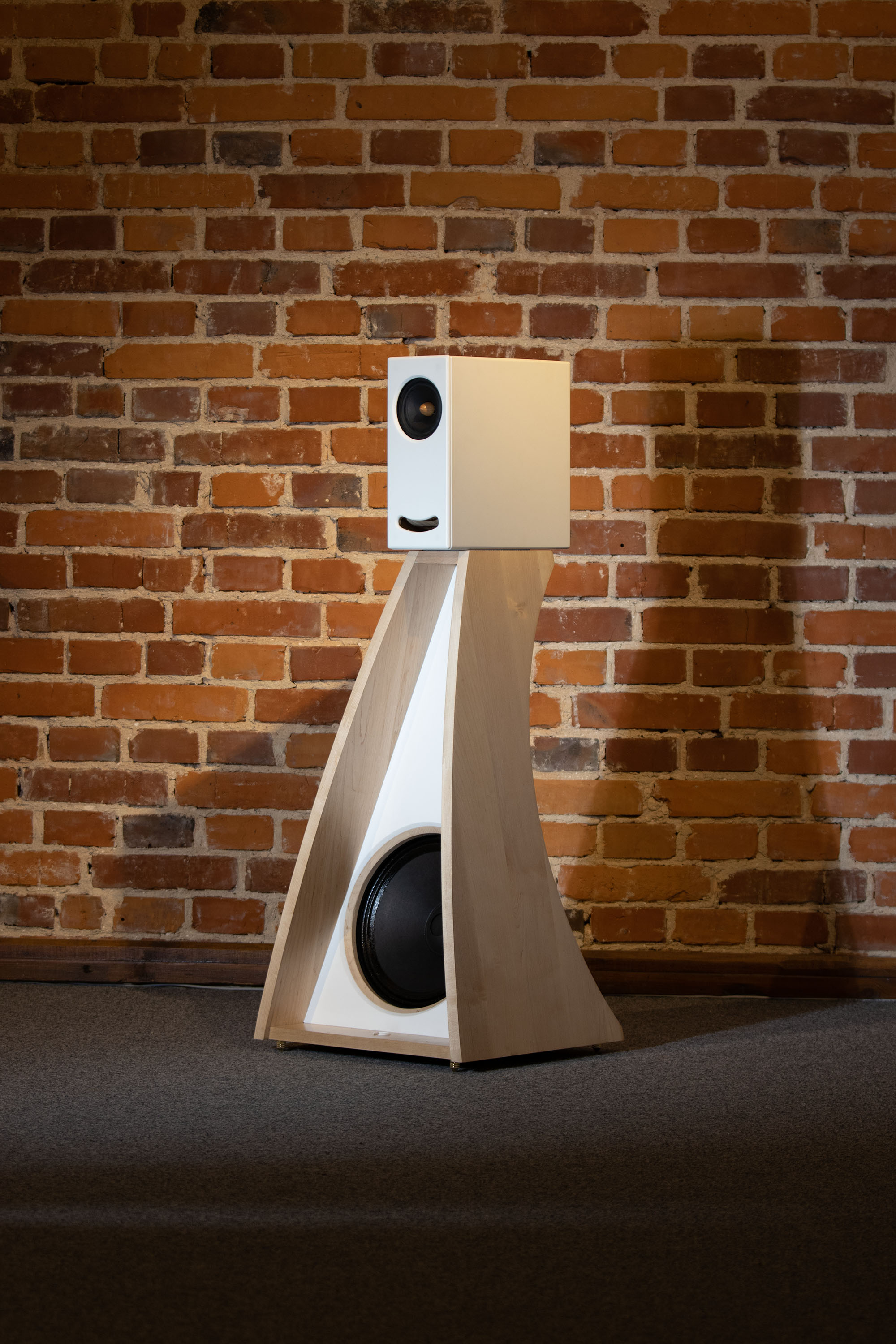 Side view of the Closer Acoustics The Full OGY Loudspeaker Set – Pair in solid maple finish, displayed against a wall, emphasizing the solid maple veneer and sleek design