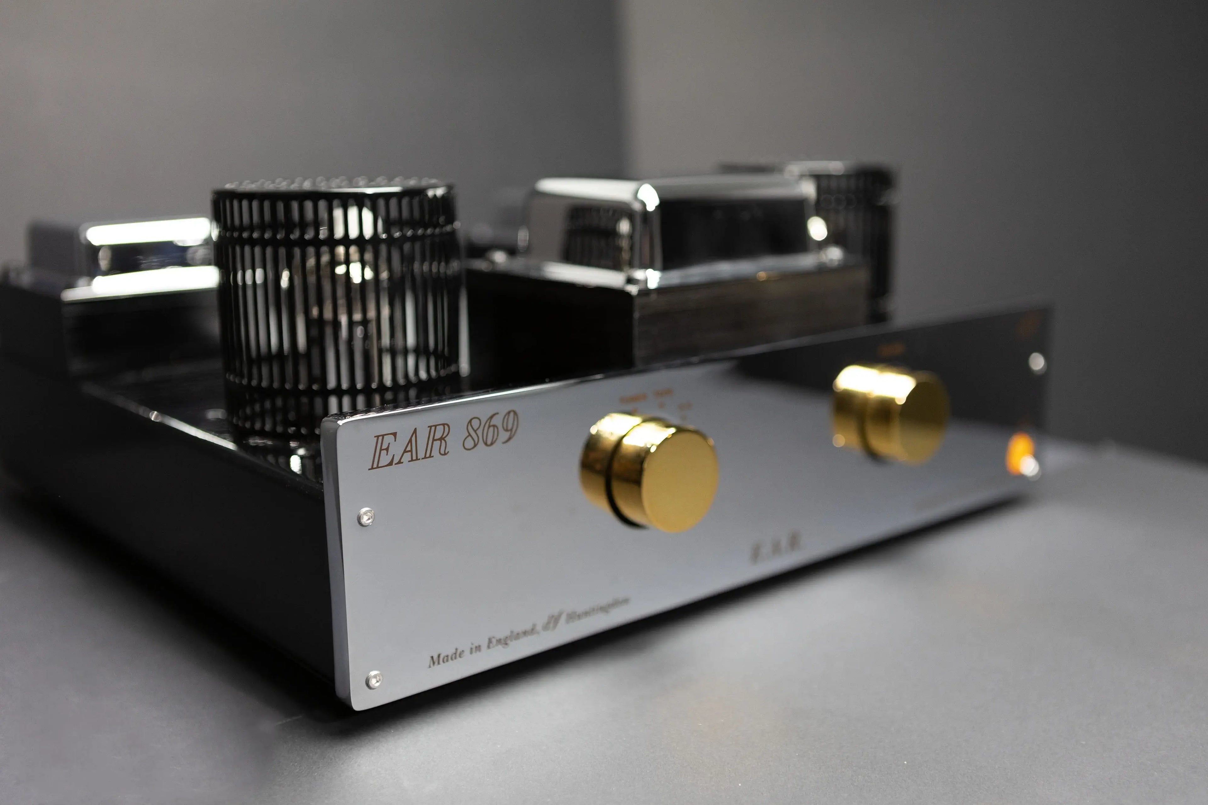 Close-up view of the Yoshino Ear 869 amplifier showing precision volume knobs and high-quality build
