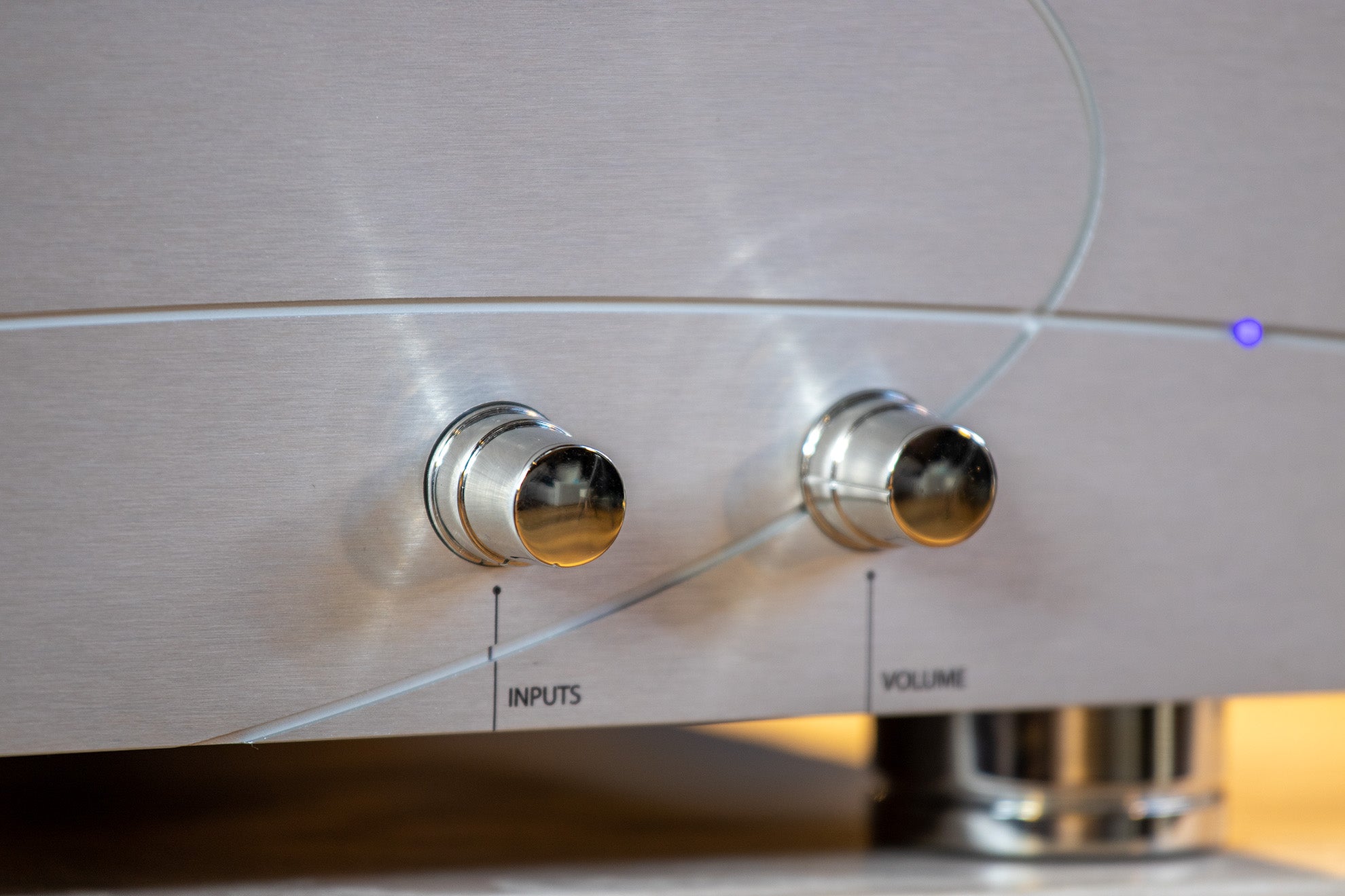 Close-up of the front panel of the elinsAudio Mille Reference amplifier, focusing on the precision knobs and premium build quality.