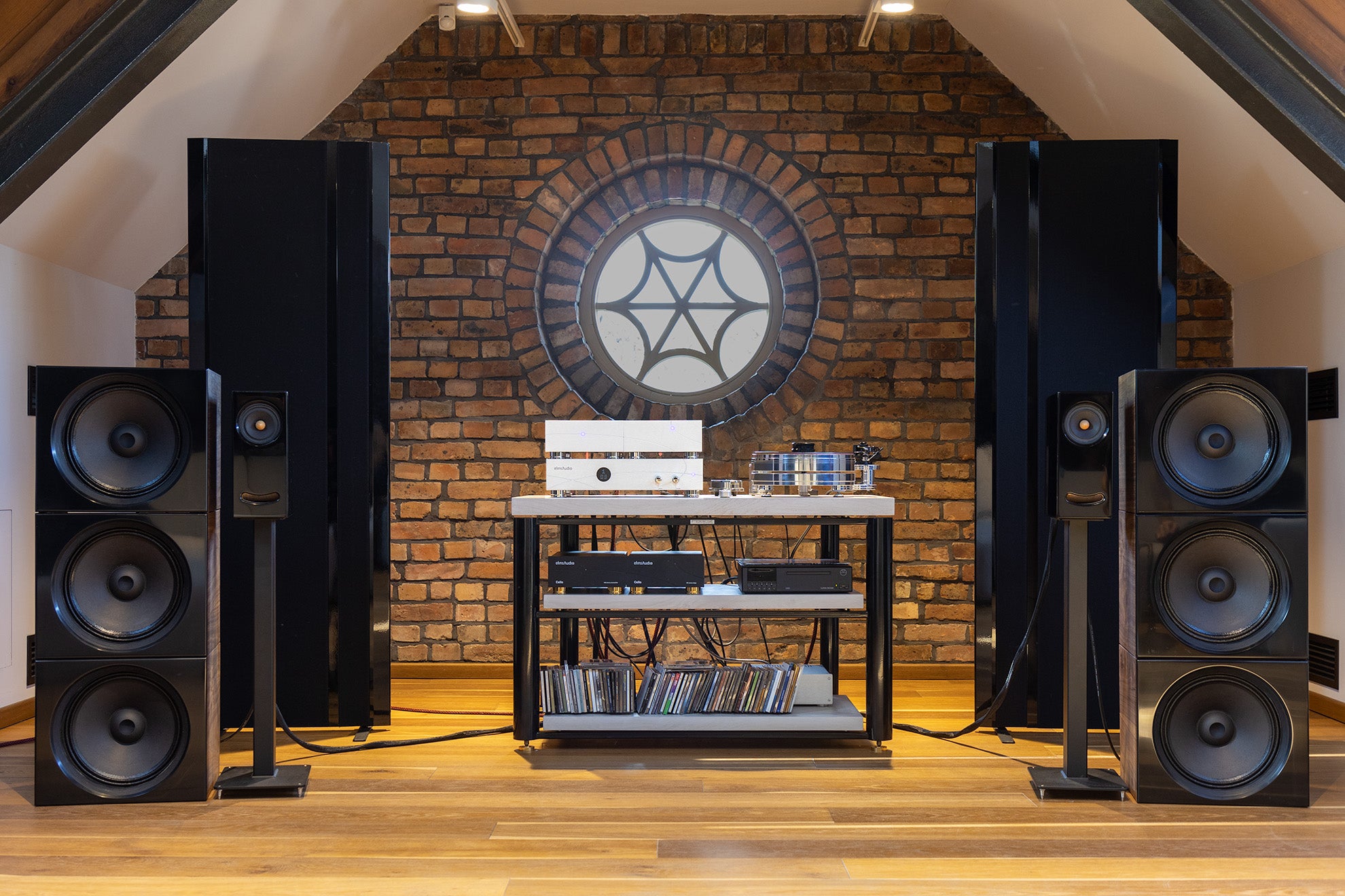elinsAudio Mille Reference amplifier in a listening room, positioned alongside high-end audio components for an immersive sound experience.