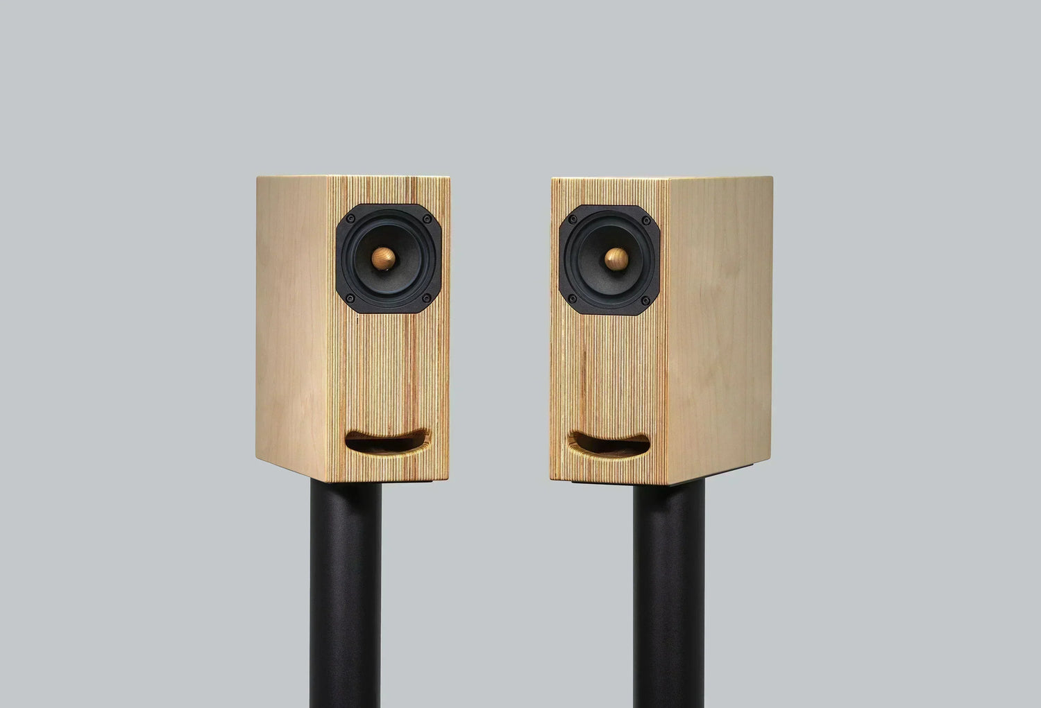 Closer Acoustics OGY bookshelf loudspeakers in plywood finish, front view, showcasing sleek design and premium craftsmanship