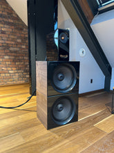Closer Acoustics OGY Plus 2 x BOBs set in a listening room, featuring piano black fronts and walnut veneered sides, designed for superior audio performance and style