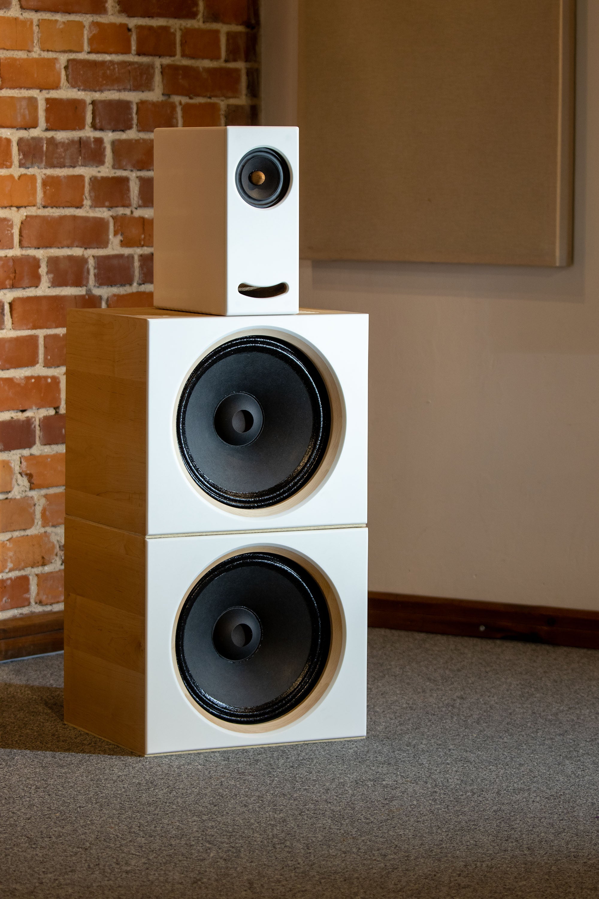 Side view of the Closer Acoustics OGY plus 2 x BOBs set with maple veneered sides, illustrating the elegant wood finish and sleek design of the speaker setup