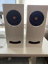 Two white Closer Acoustics Ogy speakers placed side by side, showcasing their sleek, minimalist design and premium audio craftsmanship.