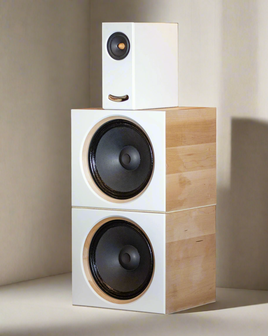 Closer Acoustics OGY plus 2 x BOBs set with white fronts and maple veneered sides, placed in a modern living room for a sleek, high-end audio experience