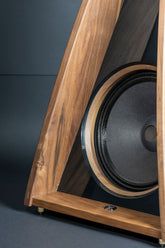 Close-up of the premium walnut veneer texture on the OGY Bass speaker.