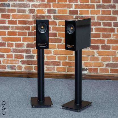 Closer Acoustics OGY Bookshelf Loudspeakers placed on ER 700 stands with a black finish, demonstrating the elegant and modern setup for audiophile listening.