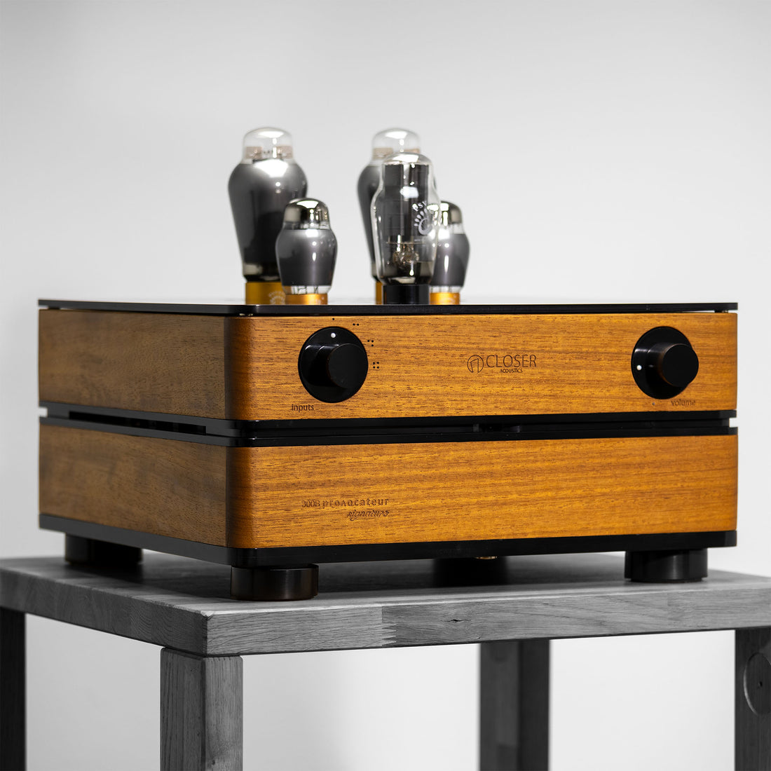 Closer Acoustics 300B Provocateur Signature amplifier in Iroko finish, placed on a wooden table, highlighting its refined design and premium build quality.