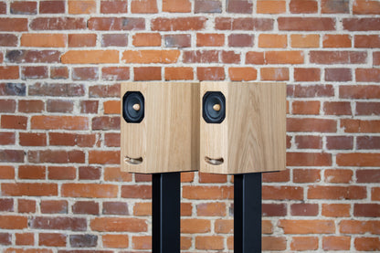 OGY bookshelf speakers in Oak veneer – full frontal and side view highlighting natural wood grain and sleek design